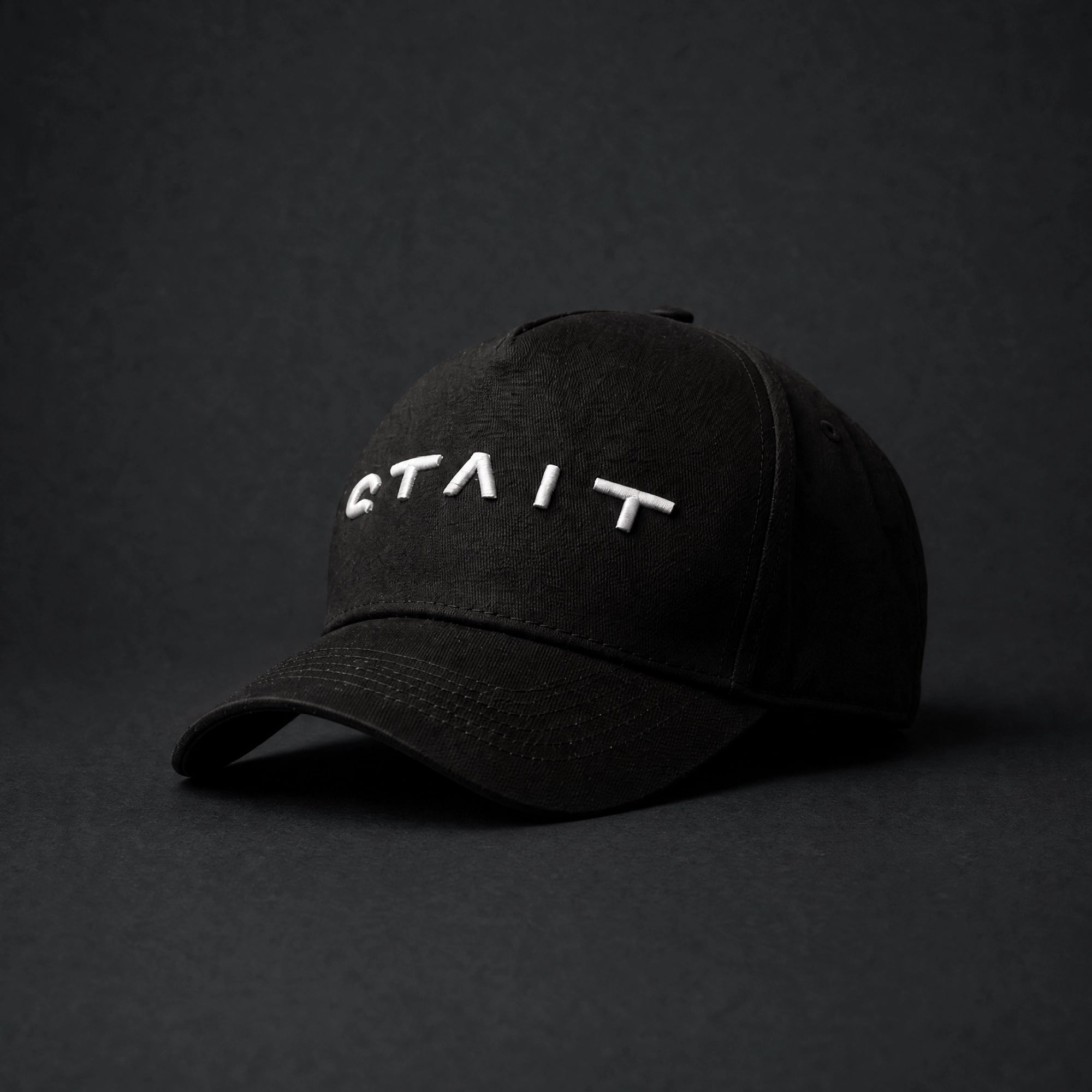 STAIT black cap with white logo on the front
